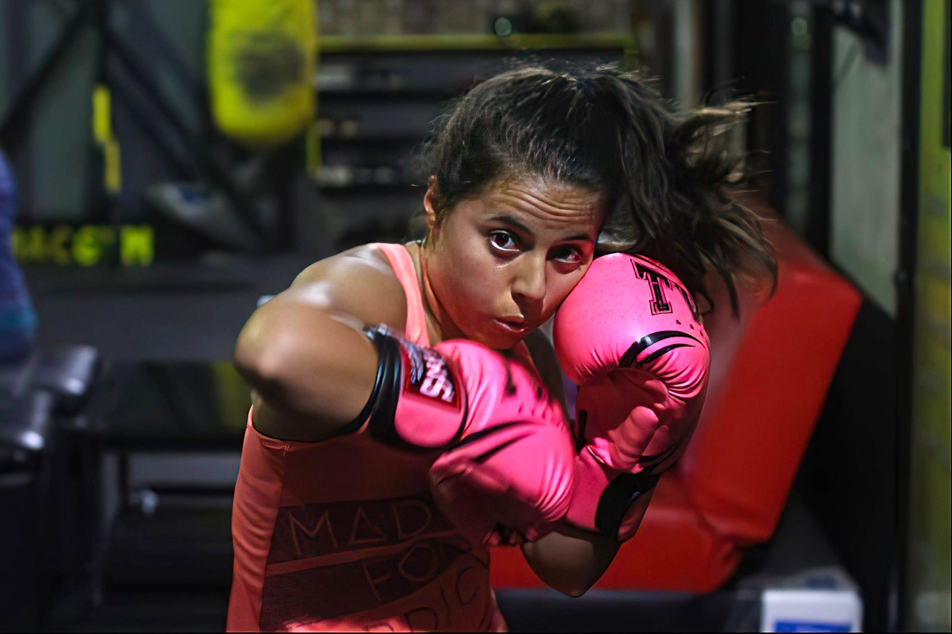 Student throwing a punch in pink gloves