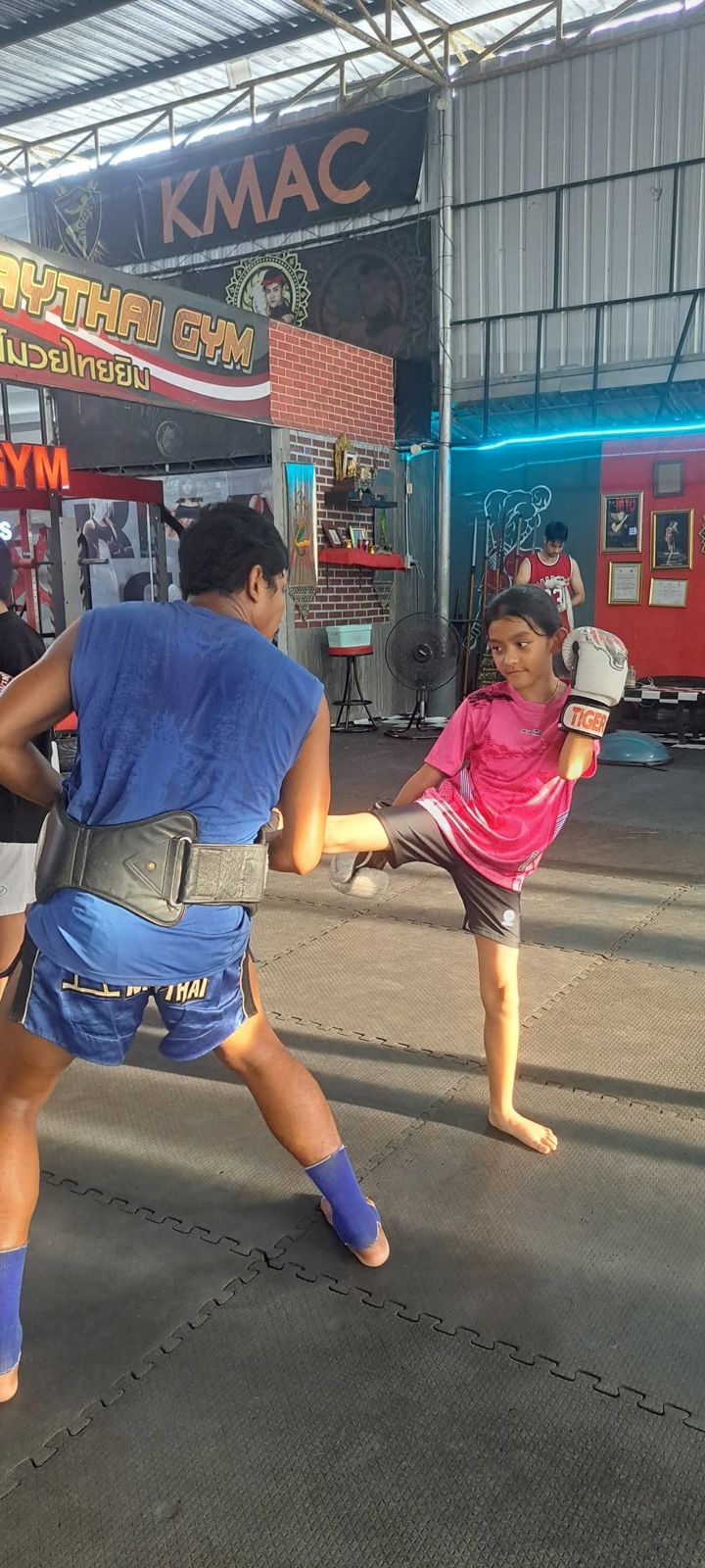 Girl kicking a pad in kids class