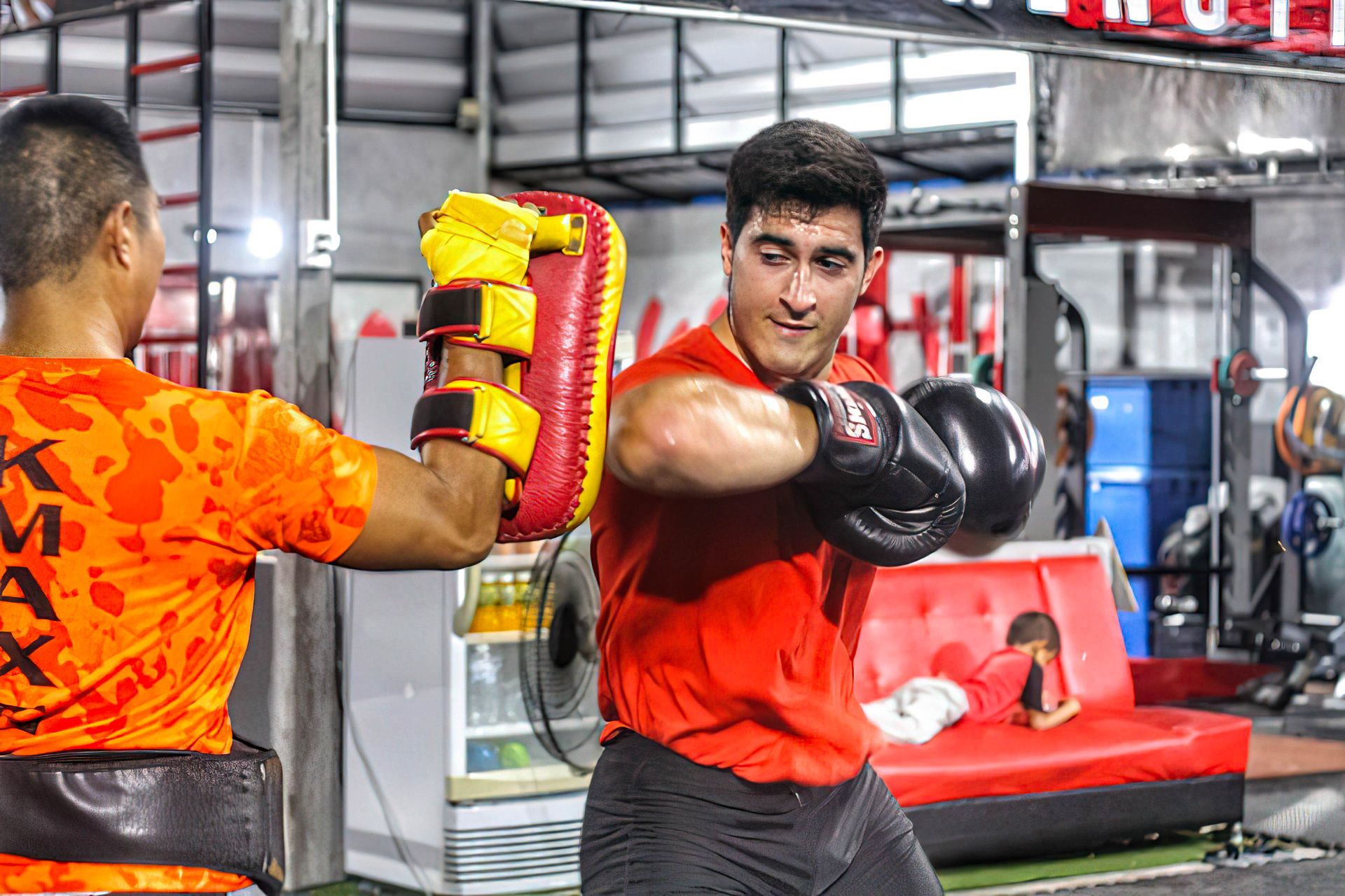 Private Muay Thai lesson with a trainer holding pads